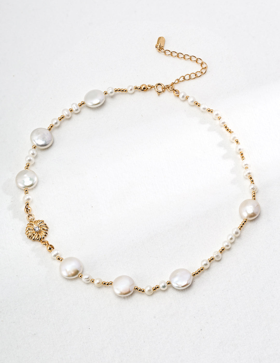 A high-resolution studio shot of the Cressida necklace, focusing on the 1.2x0.6cm pave-set centerpiece and the uniform 5mm pearls. This main visual emphasizes the premium S925 silver craftsmanship and the radiant vintage gold finish.
